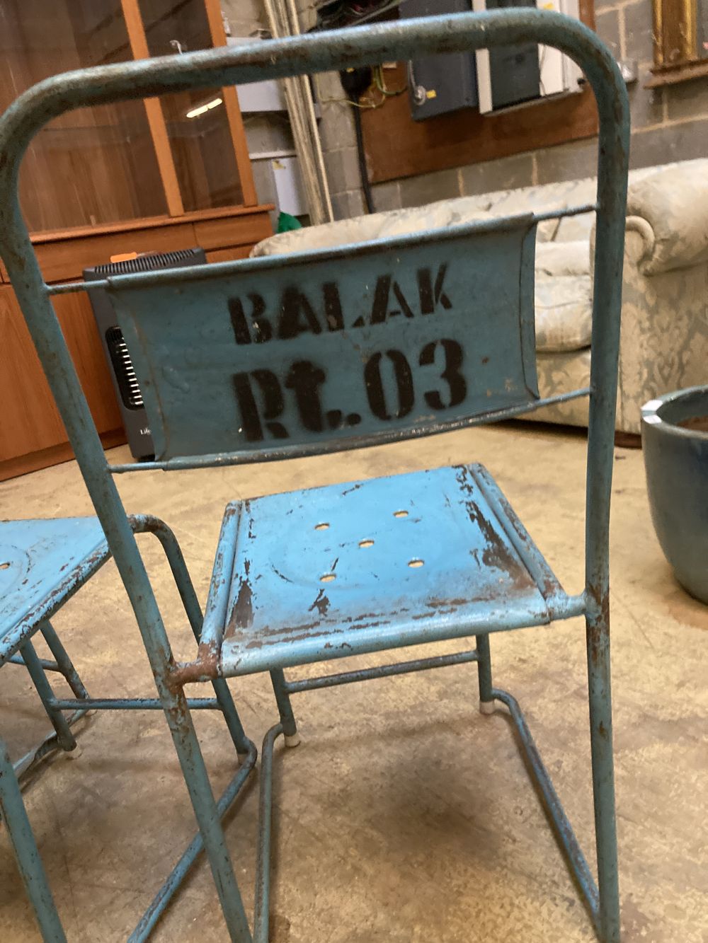 Four painted metal stacking chairs
